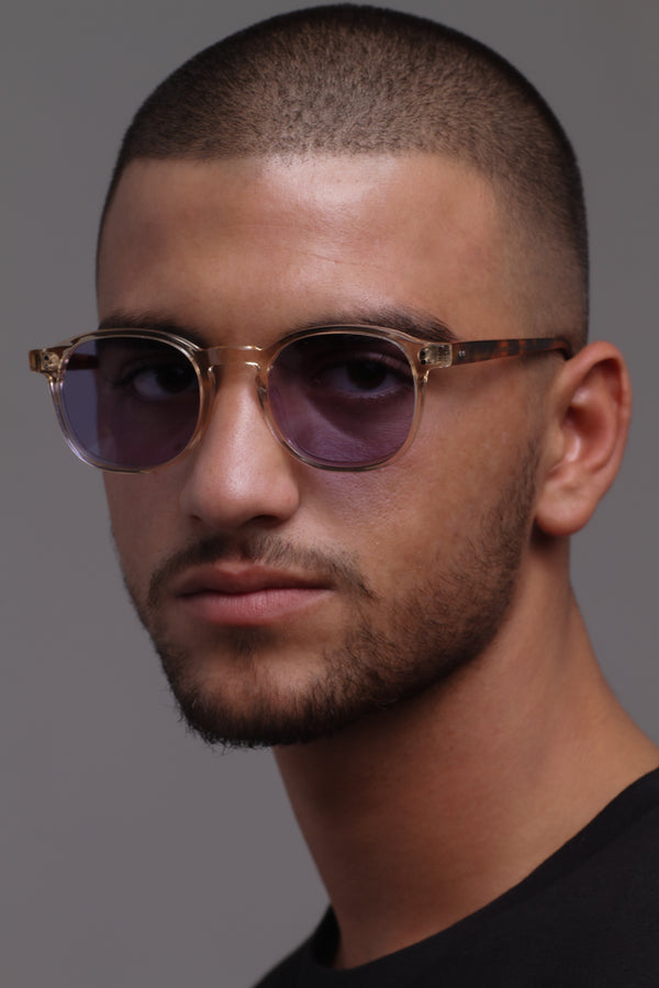 man wears transparent sunglasses with pruple tinte lens
