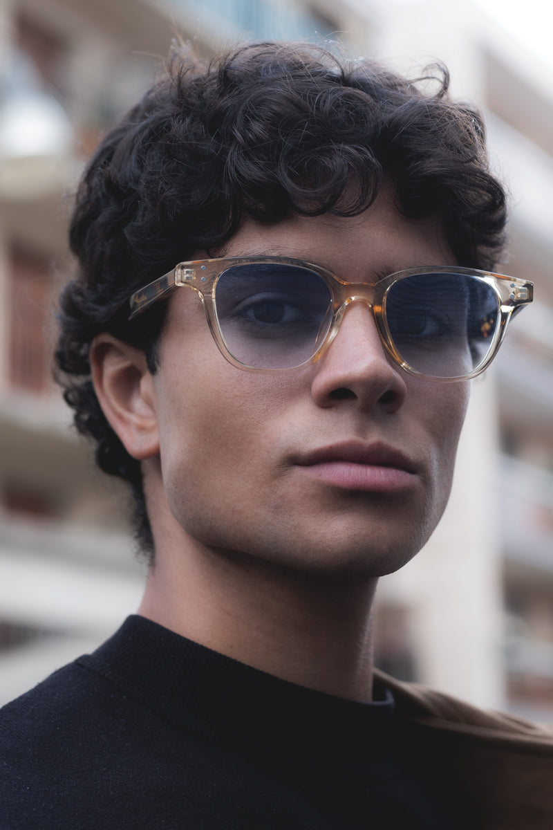 man with clear transparent frame with blue tinted lenses