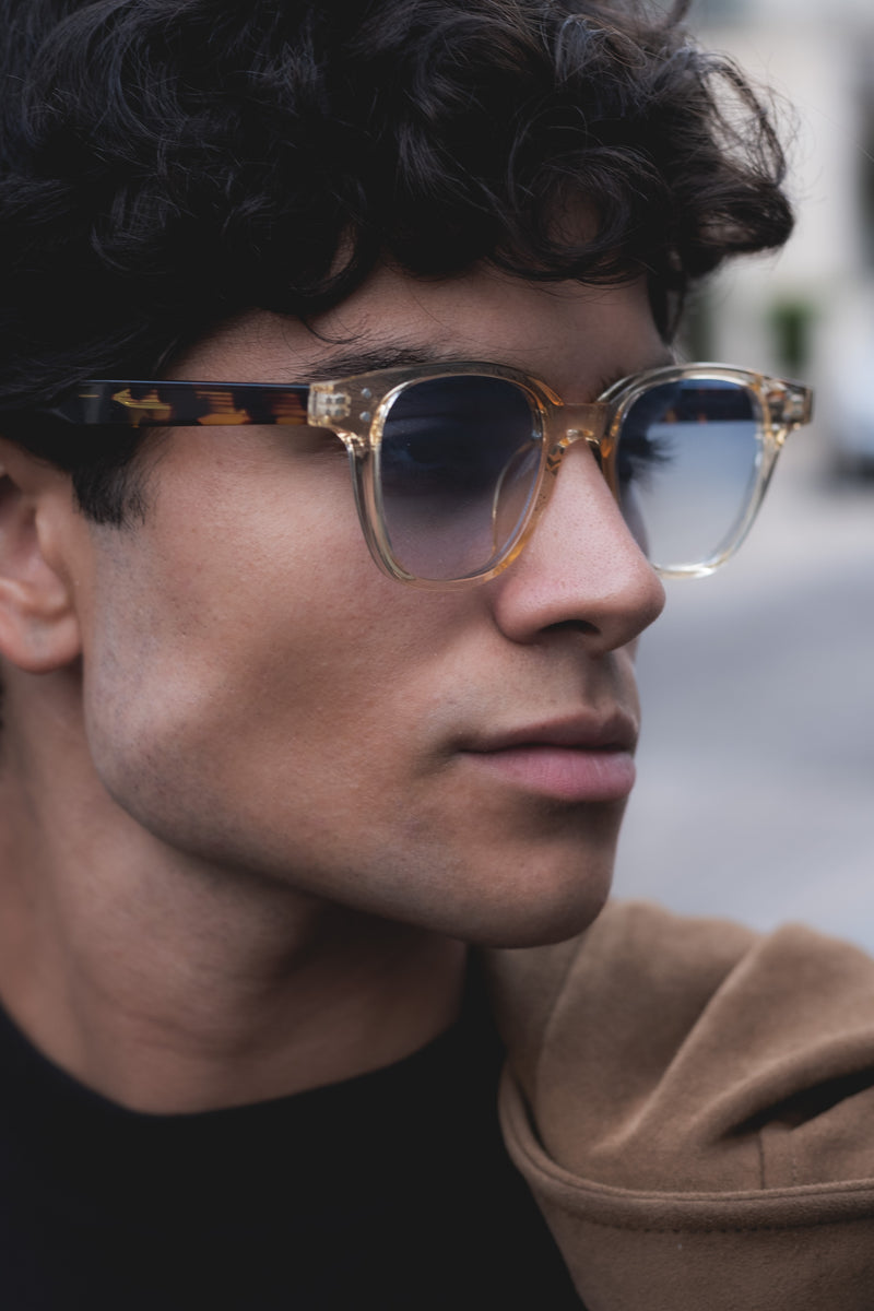 man wearing clear transparent sunglasses with blue tinted lenses